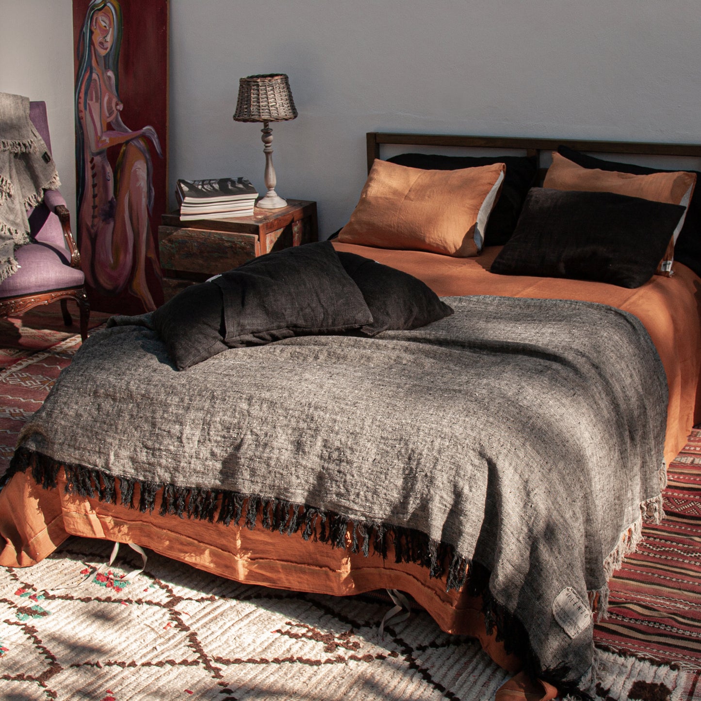 Plaid de lino negro jaspeado con natural y sábanas teja